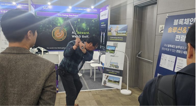 Visitor taking a swing beside the SMARTGOLF AIX display